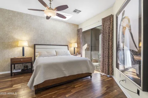 a bedroom with a large bed and a chandelier