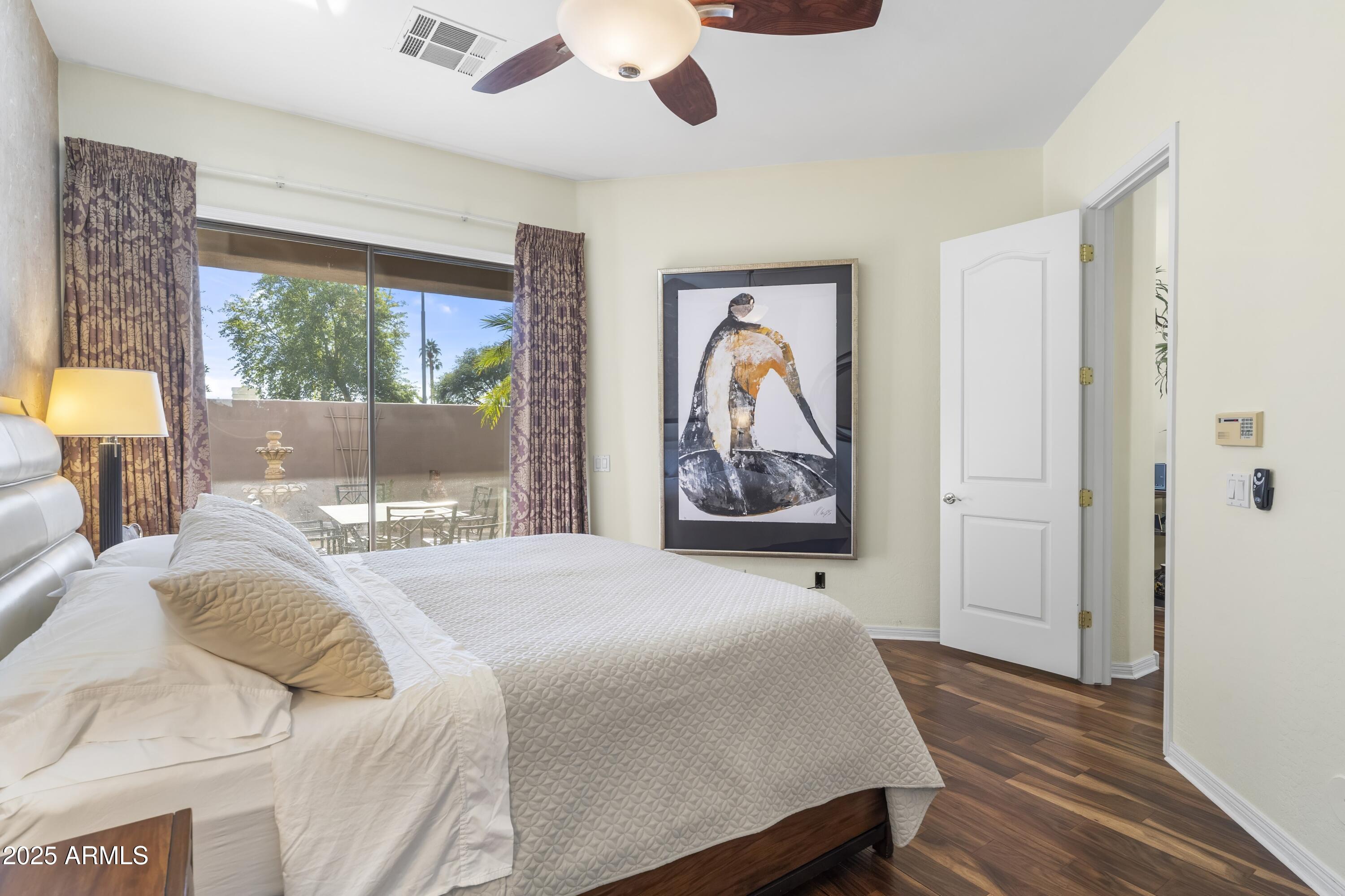 7267 East Vaquero Drive Scottsdale, AZ 85253 - Photo 19 of 37 a bedroom with a bed and a painting on the wall