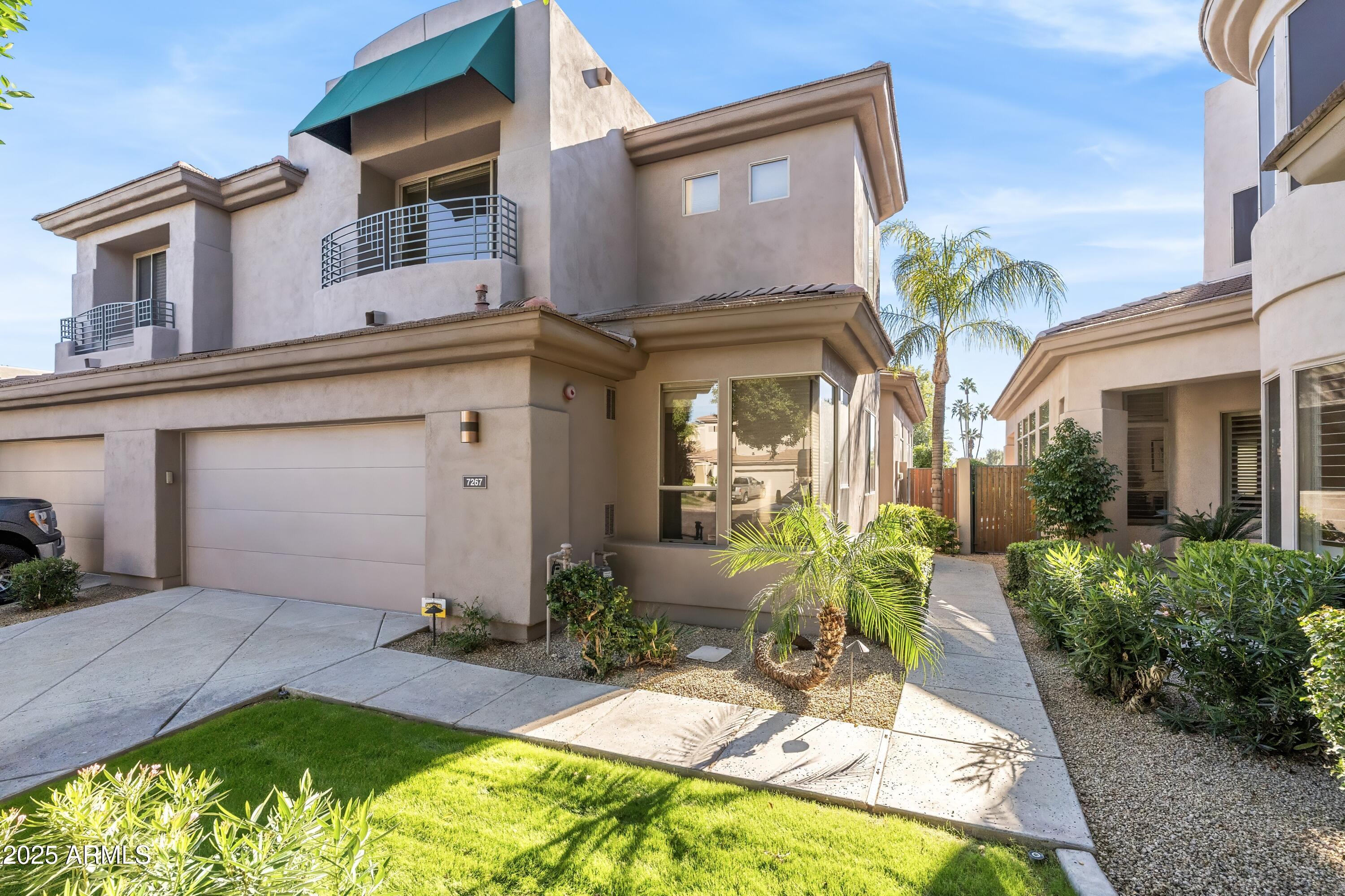 7267 East Vaquero Drive Scottsdale, AZ 85253 - Photo 2 of 37 a front view of a house with a yard