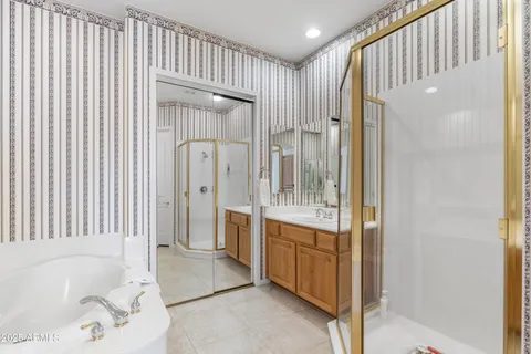 a spacious bathroom with a tub shower and sink