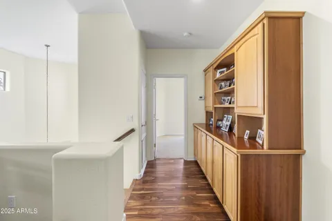 a view of a hallway with wooden floor and staircase