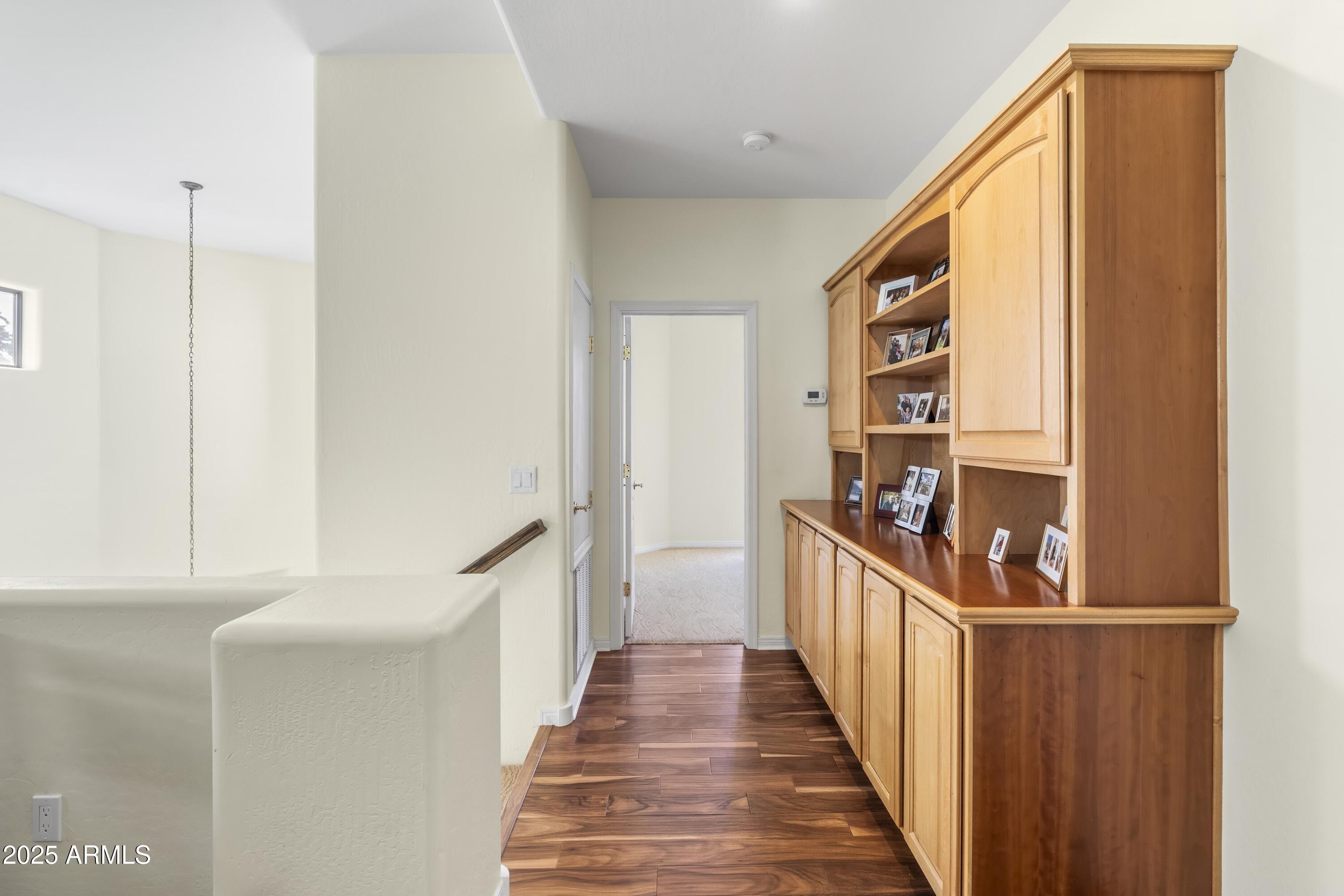 7267 East Vaquero Drive Scottsdale, AZ 85253 - Photo 25 of 37 a view of a hallway with wooden floor and staircase