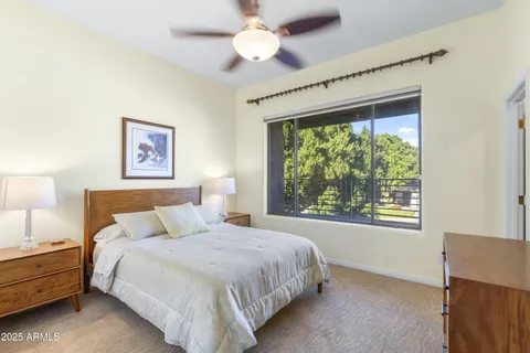 a bedroom with a large bed and a window