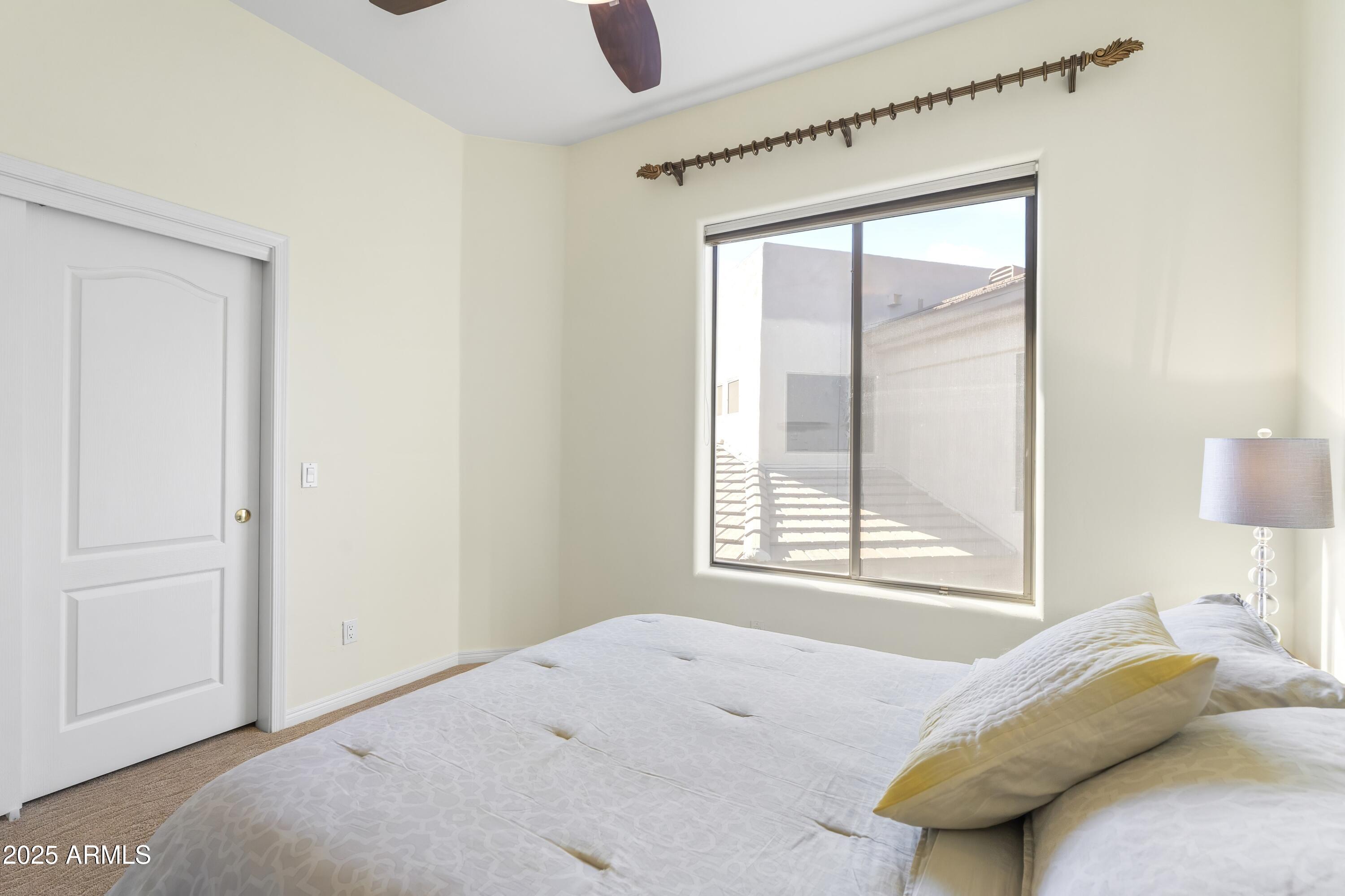 7267 East Vaquero Drive Scottsdale, AZ 85253 - Photo 29 of 37 a bedroom with a bed and a window