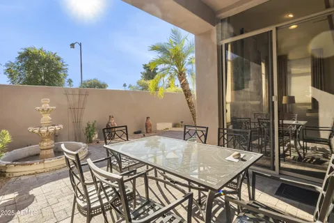 a view of a balcony dining table and chairs