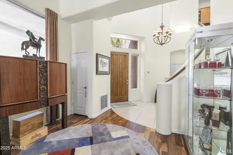 a view of a hallway with furniture and wooden floor
