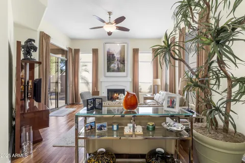 a living room with furniture a dining table and a fireplace
