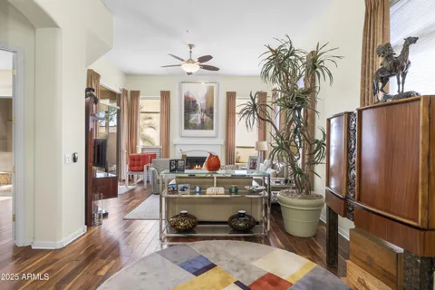 a living room with furniture a window and a potted plant