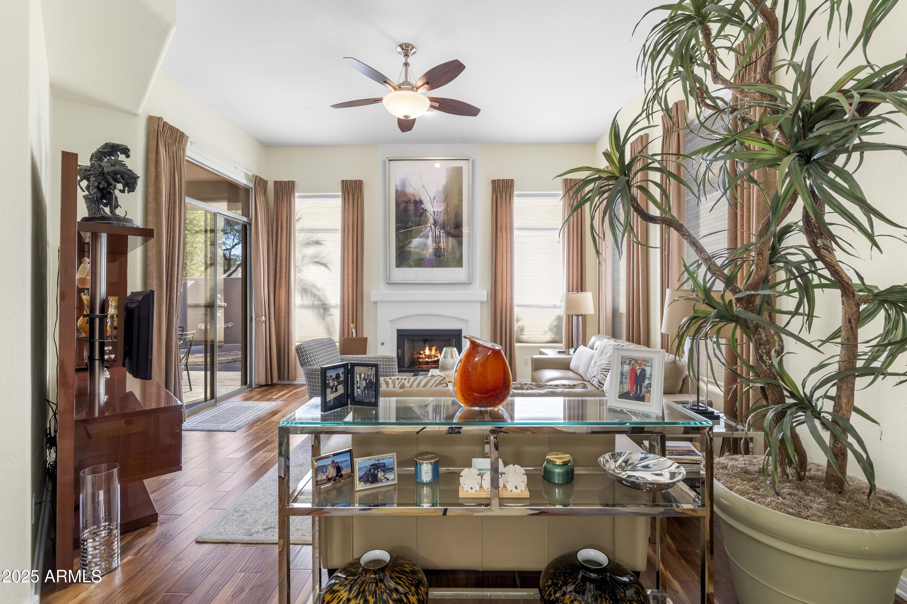 7267 East Vaquero Drive Scottsdale, AZ 85253 - Photo 9 of 37 a living room with furniture a dining table and a fireplace