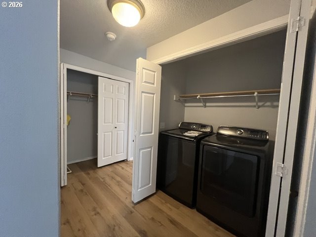 659 Northeast 162nd Avenue, Unit 302 Portland, OR 97230 - Photo 12 of 17 a kitchen with a refrigerator and wooden floor