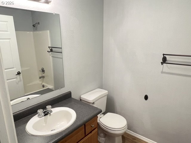 659 Northeast 162nd Avenue, Unit 302 Portland, OR 97230 - Photo 13 of 17 a bathroom with a sink a toilet and a mirror