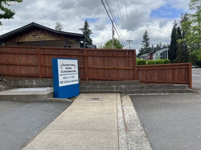 659 Northeast 162nd Avenue, Unit 302 Portland, OR 97230 - Photo 2 of 17 a view of a street with wooden fence