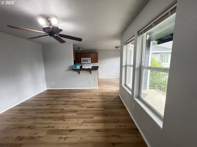 659 Northeast 162nd Avenue, Unit 302 Portland, OR 97230 - Photo 7 of 17 a view of a livingroom with wooden floor and a ceiling fan