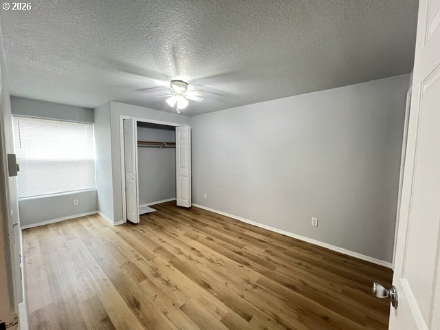 659 Northeast 162nd Avenue, Unit 302 Portland, OR 97230 - Photo 10 of 17 an empty room with wooden floor and windows