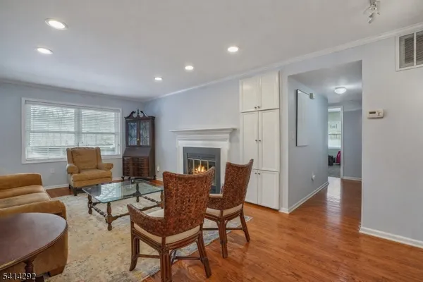 a view of a room with furniture and wooden cabinets