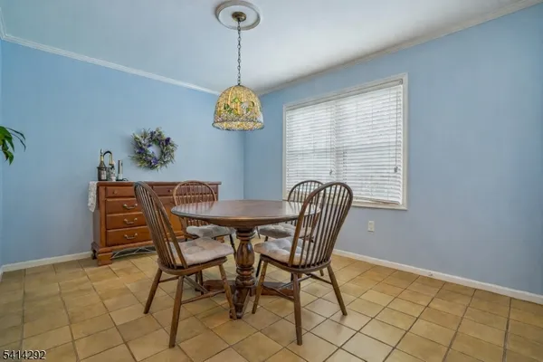 a view of a dining room that has a table and chairs