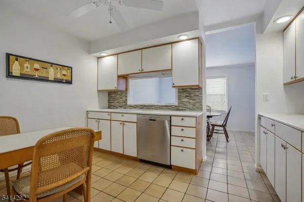 a kitchen with cabinets and chairs