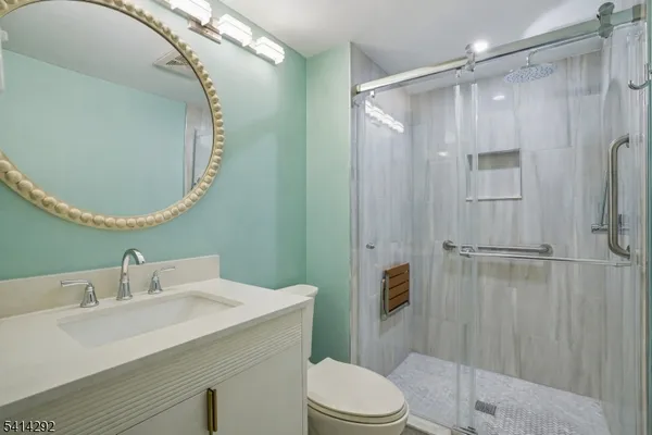 a bathroom with a sink a toilet and shower