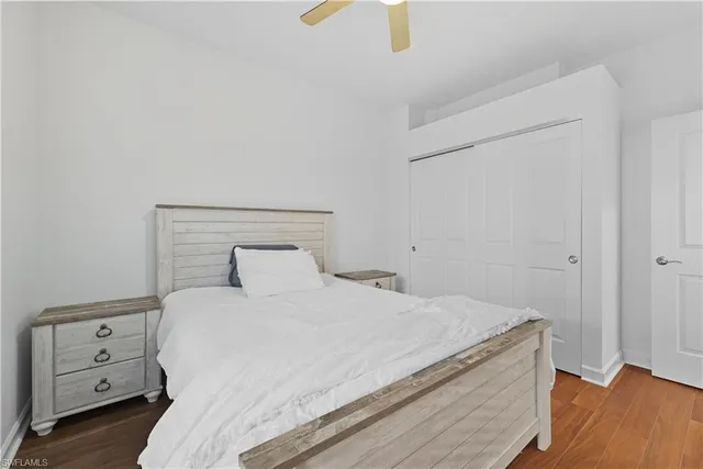 a bedroom with a bed and a night stand