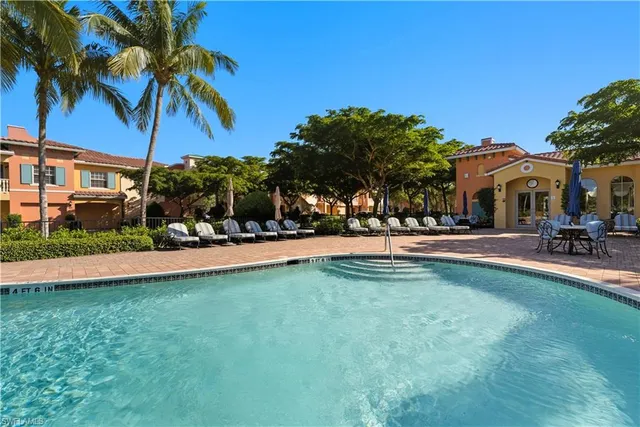 a view of swimming pool with outdoor seating and a garden