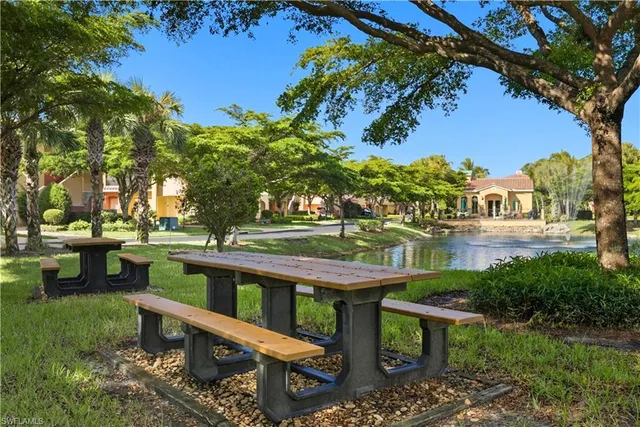 a view of a bench in the garden near a lake