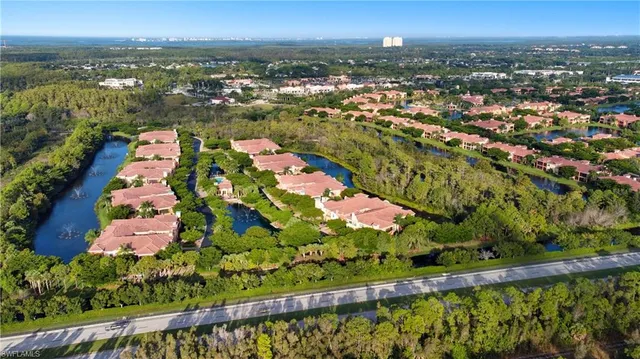 an aerial view of residential houses with outdoor space and seating