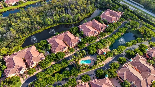 an aerial view of a house with a garden and lake view