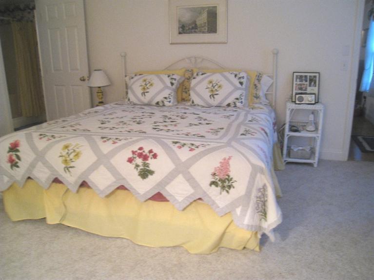28 Goose Point Road Centerville, MA 02601 - Photo 17 of 33 a bedroom with a bed and painting on the wall