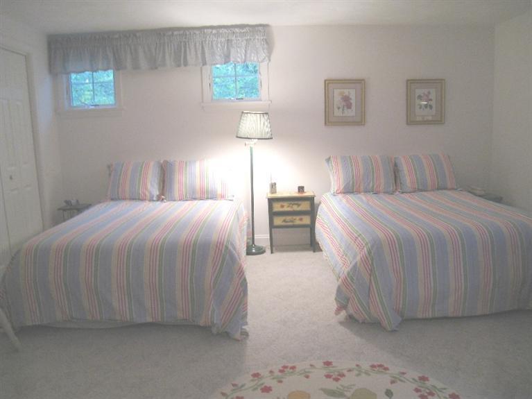 28 Goose Point Road Centerville, MA 02601 - Photo 23 of 33 a bedroom with a bed and a night stand
