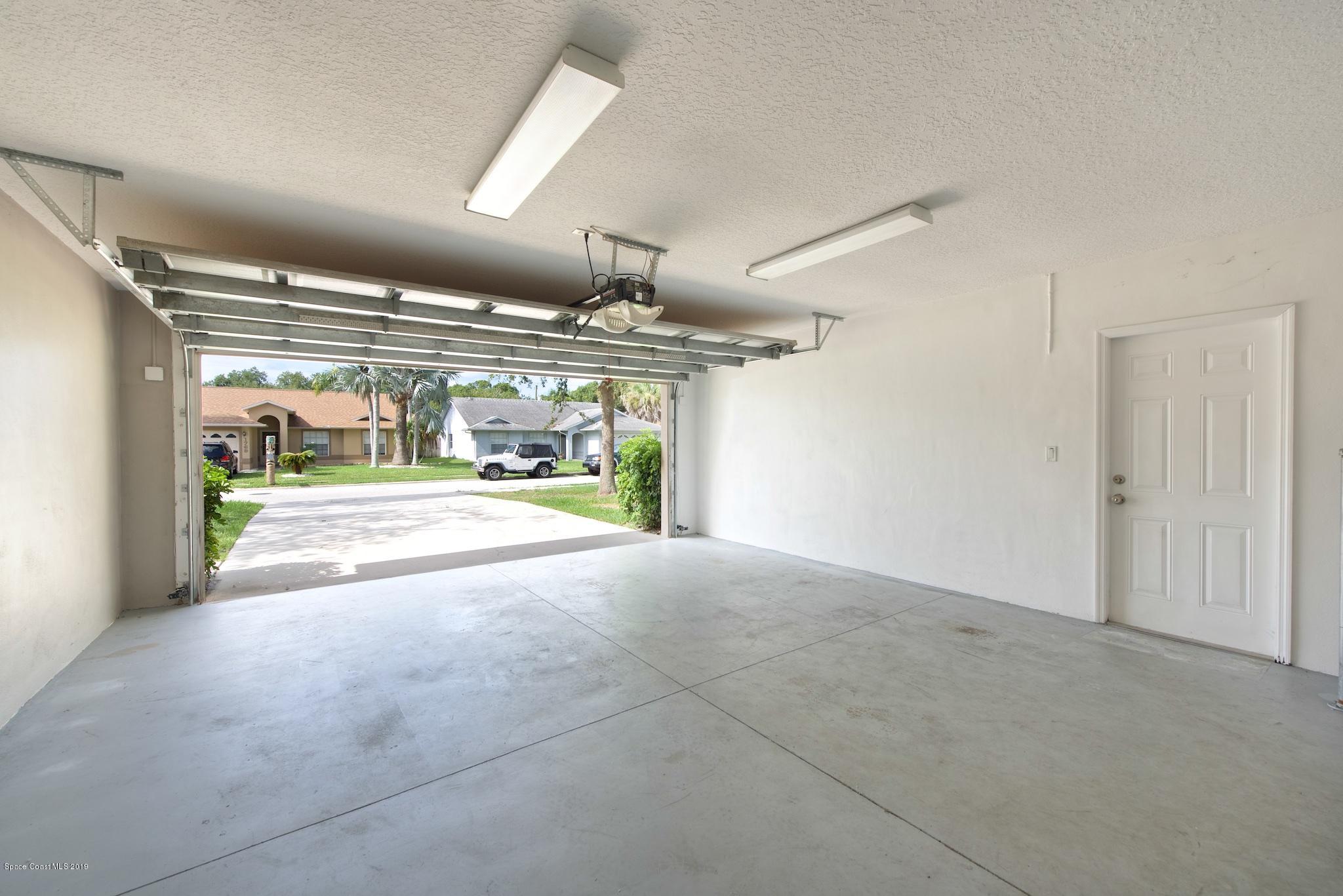 1768 Palm Ridge Road Melbourne, FL 32935 - Photo 16 of 20 a view of parking and garage
