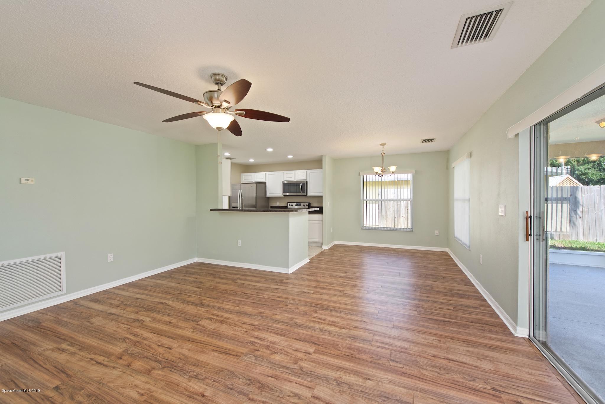 1768 Palm Ridge Road Melbourne, FL 32935 - Photo 4 of 20 a view of kitchen and empty room with wooden floor