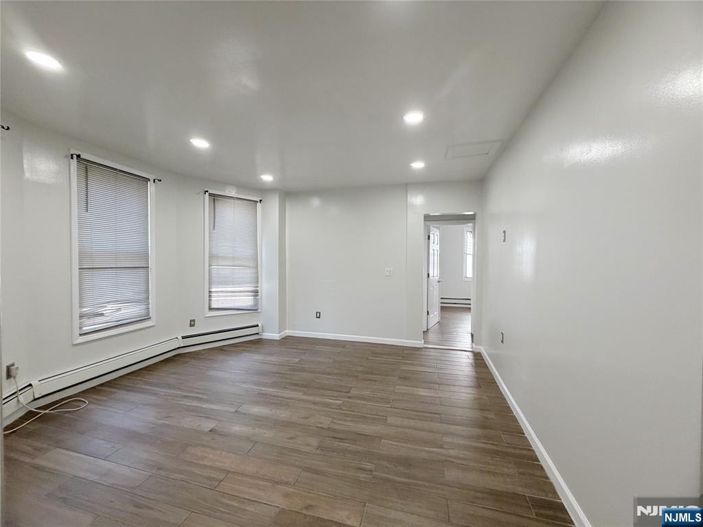 26 River Edge Road River Edge, NJ 07661 - Photo 4 of 10 a view of an empty room with wooden floor and a window