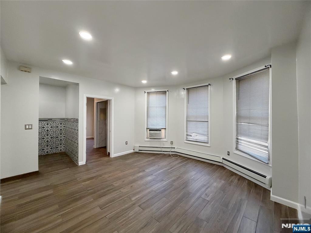 26 River Edge Road River Edge, NJ 07661 - Photo 5 of 10 a view of an empty room with wooden floor and window