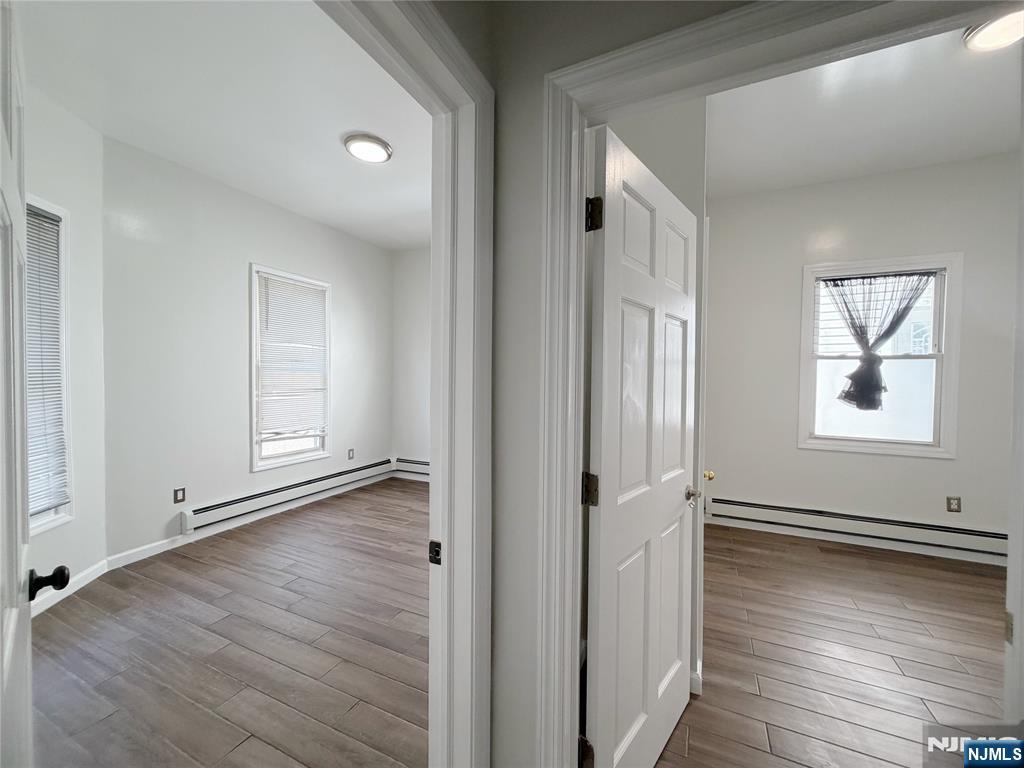 26 River Edge Road River Edge, NJ 07661 - Photo 7 of 10 an empty room with wooden floor and windows