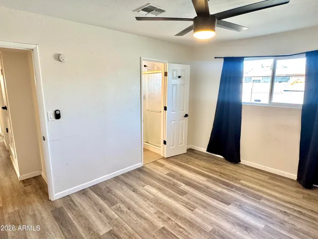 a bathroom with a sink mirror and toilet
