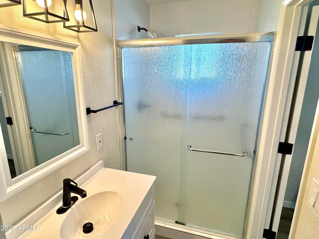 an empty room with window and ceiling fan