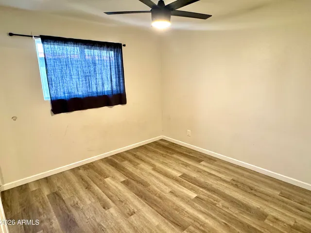 a view of a room with wooden floor and closet