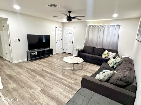 a living room with furniture and a flat screen tv