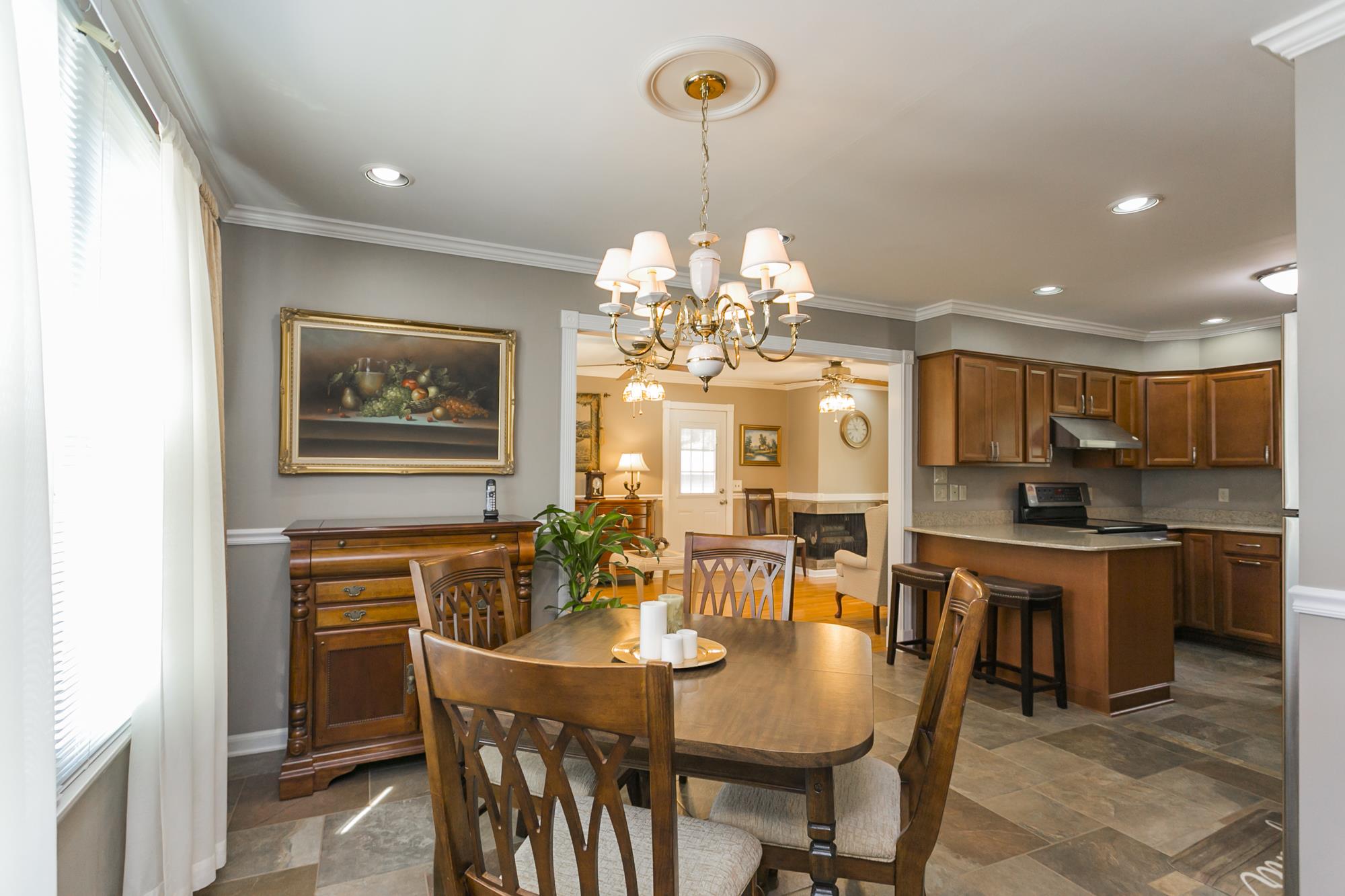 605 Baton Rouge Court Hermitage, TN 37076 - Photo 3 of 24 a view of a dining room with furniture a chandelier and wooden floor