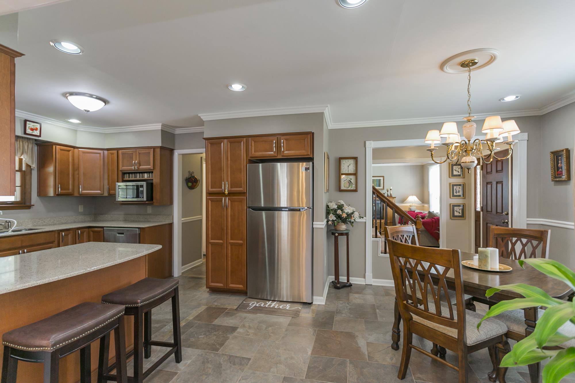 605 Baton Rouge Court Hermitage, TN 37076 - Photo 6 of 24 a kitchen with stainless steel appliances granite countertop a refrigerator a sink a stove and a dining table with wooden floor