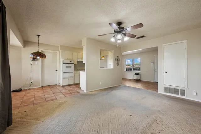 an empty room with a empty space and a ceiling fan