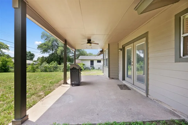 a view of a backyard with porch and garden