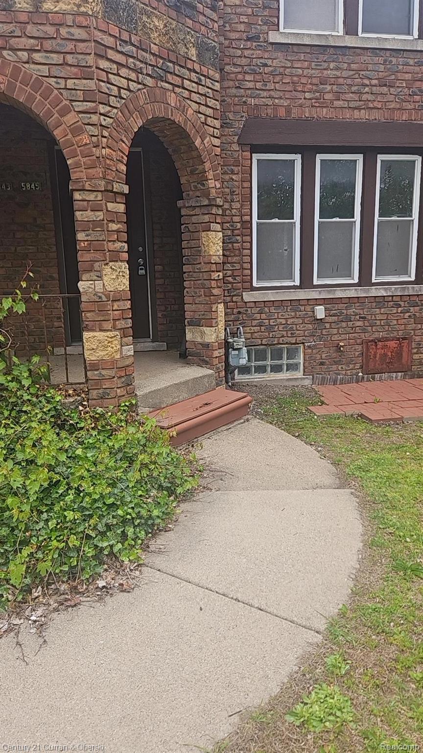 Entrance to property with brick siding