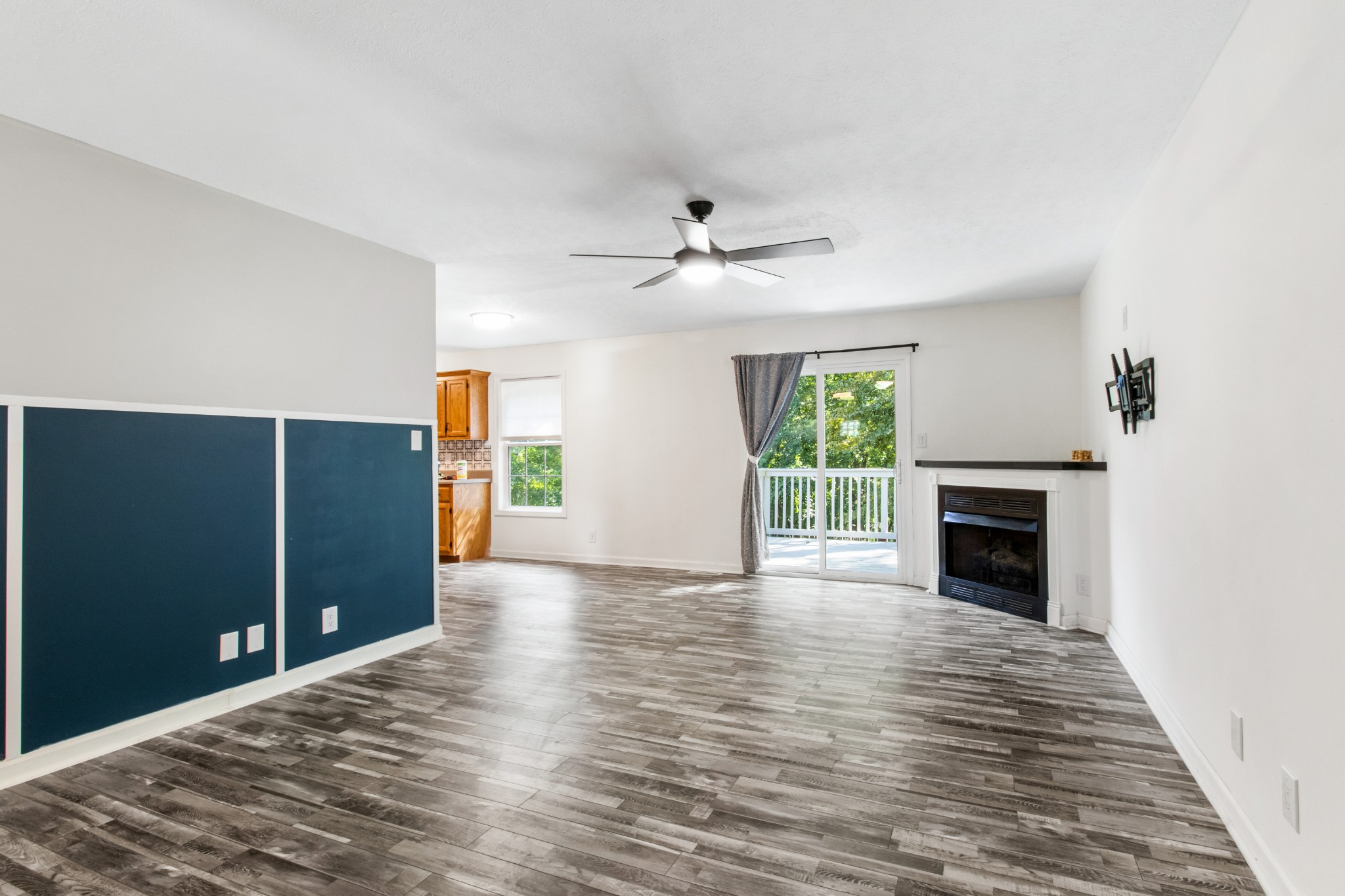 1760 Hazelwood Road Clarksville, TN 37040 - Photo 9 of 34 a view of a livingroom with a fireplace a ceiling fan and windows