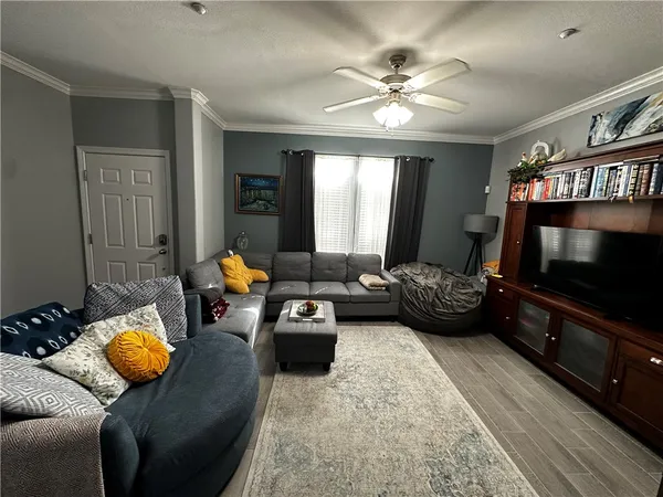 a living room with furniture and a flat screen tv