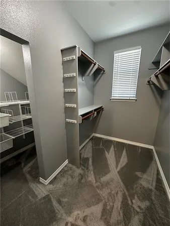a open kitchen with stainless steel appliances granite countertop a sink dishwasher a stove a refrigerator a dining table and chairs with wooden floor