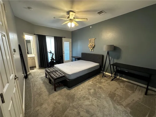 a bedroom with a bed dresser and a window