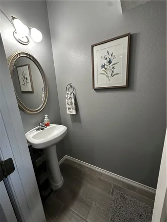 a bathroom with a sink mirror and toilet