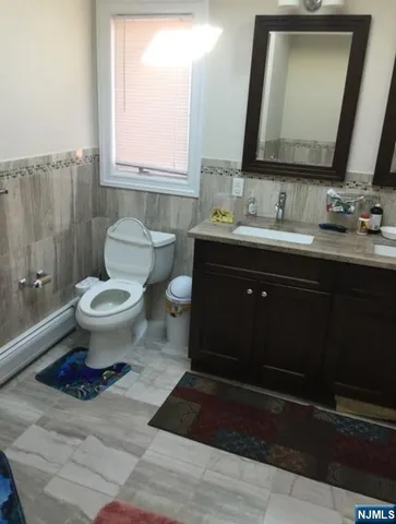 a bathroom with a toilet sink and mirror