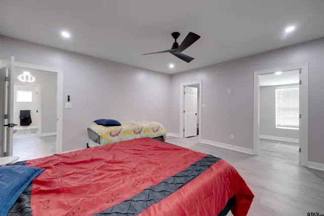 a bedroom with a bed and a window